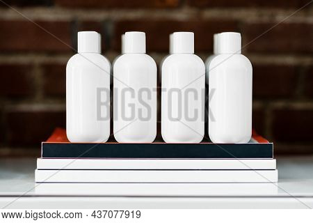 Four beauty product bottles on a shelf