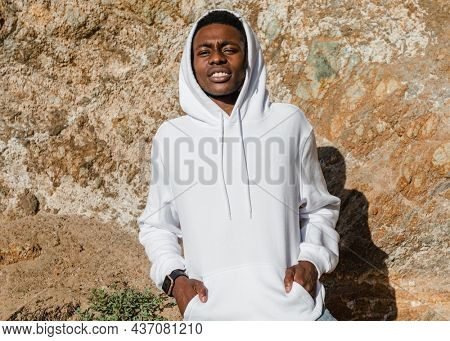 African American man in white hoodie posing outdoor photoshoot