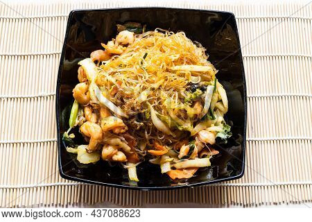 Portion Of Mien Xao Vietnamese Wok Stir-fried Glass Noodles With Vegatables And Prawns In Black Bowl