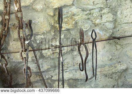 The Exhibition Of Blacksmith Craft Work Examples On The Wall In Local Ethnological Museum . Old Rust