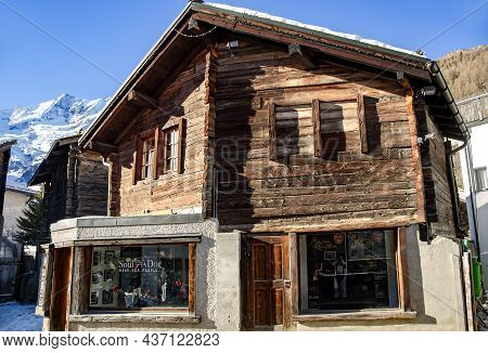 Switzerland, Saas-fee, December, 26, 2015 - Typical Old Wooden House With A Shop On The Ground Floor