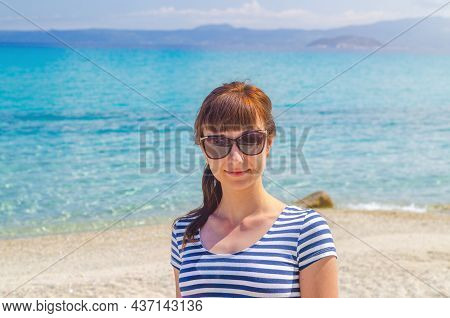 Close-up Portrait Of Young Beautiful Girl With Striped T-shirt And Sunglasses Looking At Camera And 