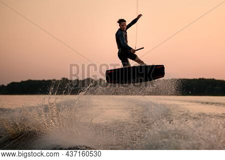 Great View Of Energy Man While Jumping In The Air On Wakeboard
