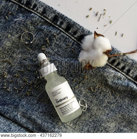 Kyiv, Ukraine - August 30, 2020 The Ordinary Niacinamide Zinc Serum Glass Bottle With Cotton Flower 