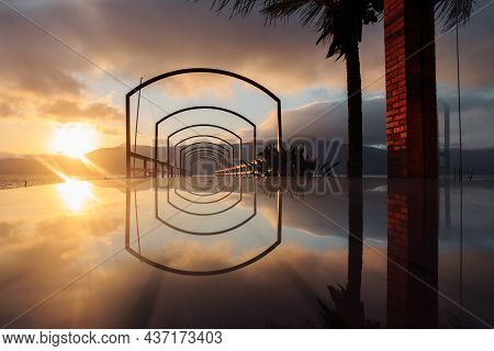 Sunset On The Pier With A Mirror Surface.