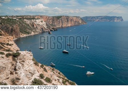 Two Rocks Stick Out Of The Water In The Middle Of The Turquoise Sea. Scenic Ocean View. Speed Boat S