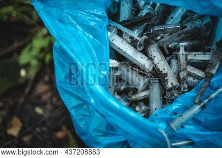 Garbage Bag With Used Disposable Medical Syringe Leaved By Drug Addicted In Park