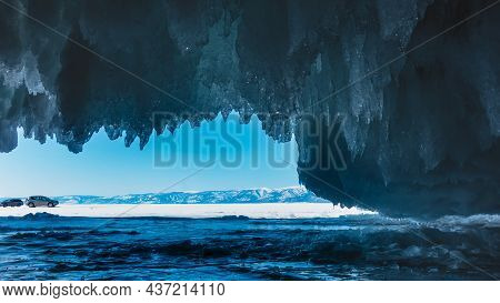 Icicles Hang From The Vault Of The Grotto Like Blue Lace Frills. Ahead, Against The Background Of Th