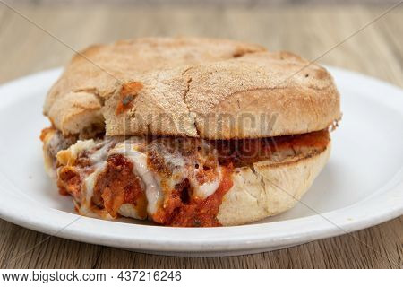 Veal Parmesan Sandwich Dripping Cheee And Sauce Out From Within The Bread For This Delicious Italian