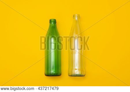 Two Empty Glass Bottle On A Yellow Background. Eco-friendly Packaging, Waste Recycling Concept, Glas