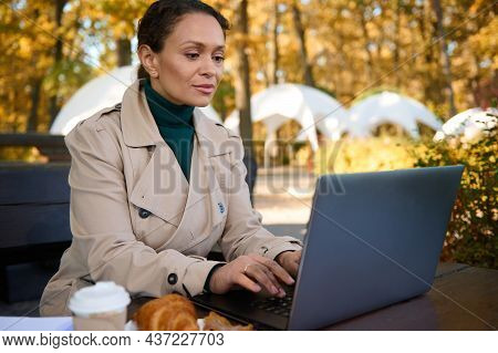 Young Confident Business Woman Working On Laptop In A Forest Cafe While Enjoying Remote Work In The 
