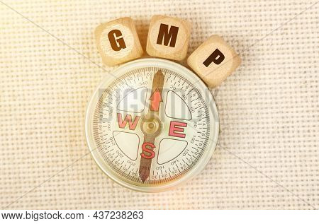 Business Concept. On The Table Is A Compass And Cubes With The Inscription - Gmp