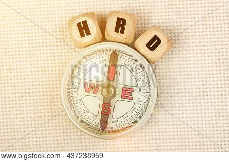 Business Concept. On The Table Is A Compass And Cubes With The Inscription - Hrd