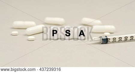 Medicine Concept. On The Table Are Capsules, A Syringe And Pills That Say - Psa