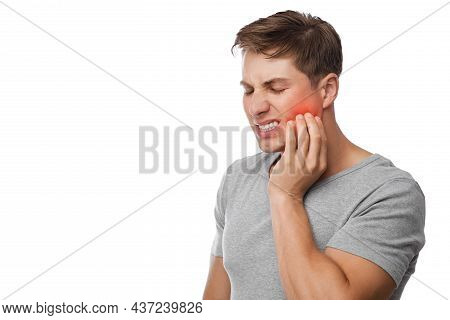 Sad Unhappy Young Handsome Caucasian Guy Suffering From Toothache, Presses Hand To Cheek, Highlighte