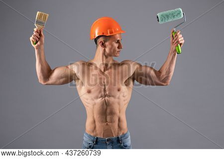Painting Has Never Been This Easy. Muscular Painter Hold Paintroller And Paintbrush. Painting