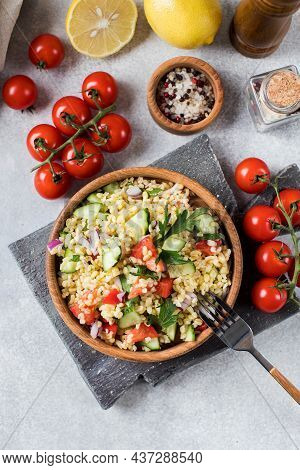 Salad With Bulgur, Tomatoes, Cucumbers And Parsley. Tabouleh Dish. Oriental Cuisine.