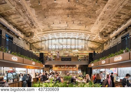 Odesa, Ukraine - June 6, 2021: Interior of the Odessa Food Market modern urban cafe with different street food vendors in Odesa, Ukraine
