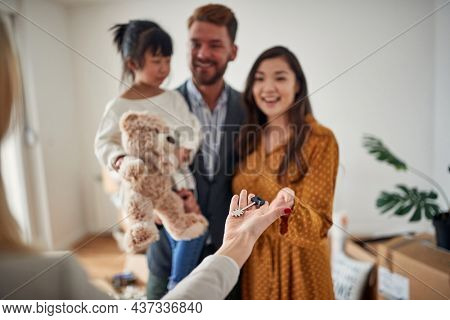 Happy multi ethnic family renting new place together; New beginning concept