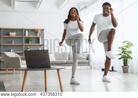Young Black Couple Doing Cross Knee To Elbow Exercise