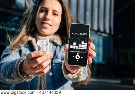 Audio Tour Online App On Digital Mobile Smartphone. Happy Young Student Woman Holding Phone Listenin