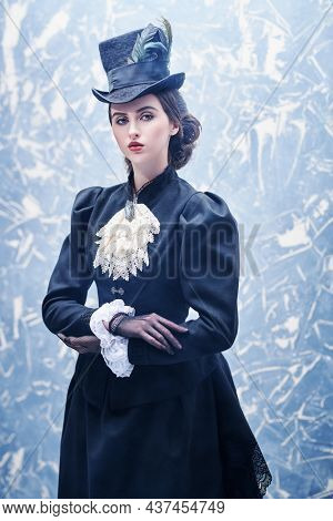 19th century women's hairstyle, makeup and costume. Portrait of a beautiful brunette lady in authentic 19th century style. Historical reconstruction.