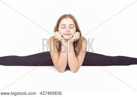 Young Caucasian Sportswoman Rhythmic Gymnast In Training Outfit During Line Split Stretching Exercis