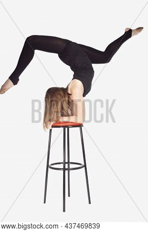 Athletic Caucasian Sportswoman Rhythmic Gymnast In Training Outfit During Legs Upward  Stretching Ex
