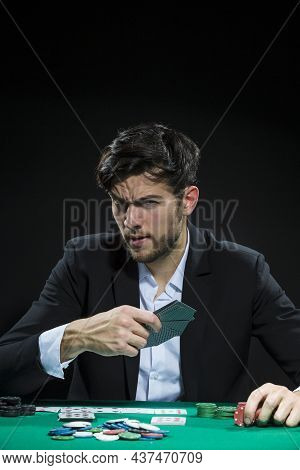 Casino Concepts. Serious Handsome Caucasian Young Pocker Player Staking And Betting To Win At Pocker