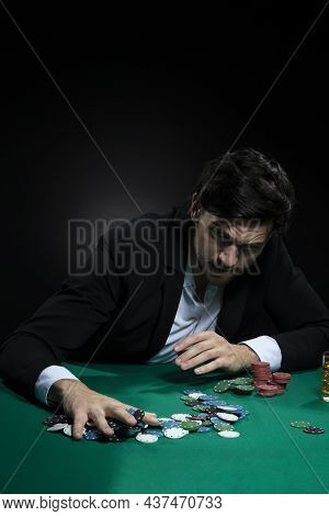 Nervous Concentrated Handsome Caucasian Brunet Young Pocker Player At Pocker Table With Chips And Ca