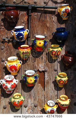 Ceramic pots on wooden door.