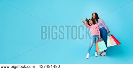 African American Woman And Girl Looking Iside Shopping Bags