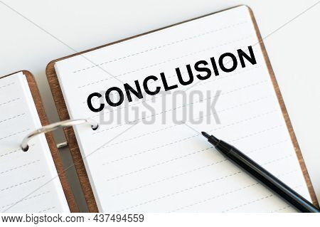 Conclusion Text On A Notebook With Marker On A Light Background