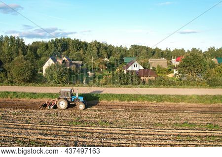 Tractor On Cultivating Field Work. Soil Tillage In Farmers Country. Agricultural Tractor On Cultivat