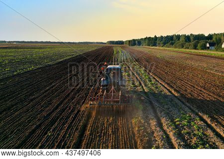 Tractor On Cultivating Field Work. Soil Tillage In Farmers Country. Agricultural Tractor On Cultivat