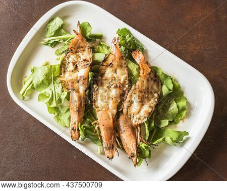 Grilled Shrimps With Garlic And Arugula From A Top View