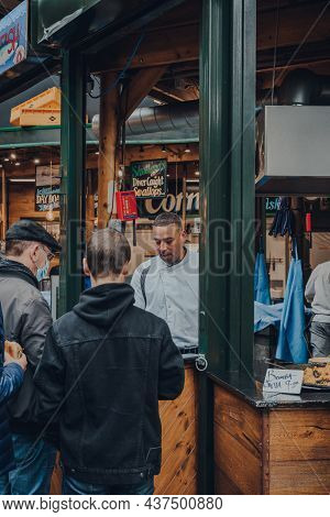 London, Uk - October 17, 2021: Man Serving Bomba Paella At The Furness Food Hut Stall Inside Borough