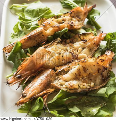 Grilled Shrimps With Garlic And Arugula From A Top View