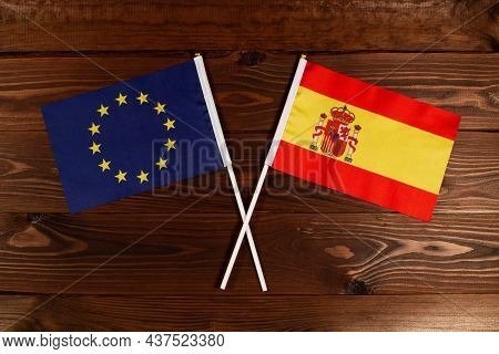 Flag Of European Union And Flag Of Spain Crossed With Each Other. The Image Illustrates The Relation