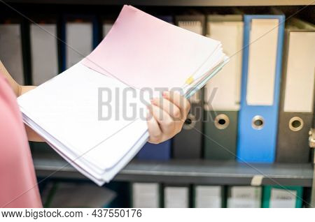 Female Hand Holding A Heap Of Documents Paper In Her Hand Preparing To Arrange In The File Folder On