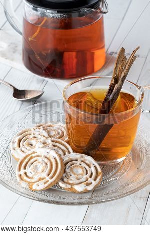 A Glass Plate Of Cinnamon Swirl Cookies Served With A Cup Of Cinnamon Chia Tea.
