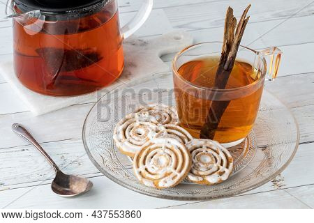 A Close Up Of A Plate Of Cinnamon Swirl Cookies Served With A Cup Of Chia Tea.