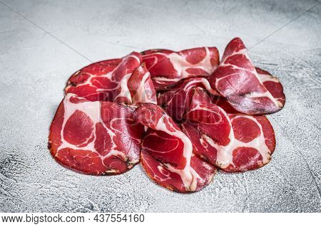 Coppa Cured Ham On Kitchen Table. White Background. Top View