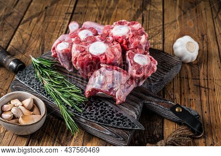 Raw Beef Oxtail Cut Meat On Wooden Cutting Board With Knife. Wooden Background. Top View