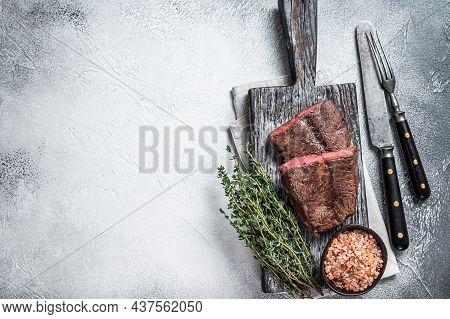 Roasted Shoulder Top Blade Or Flat Iron Beef Meat Steaks On Wooden Board. White Background. Top View