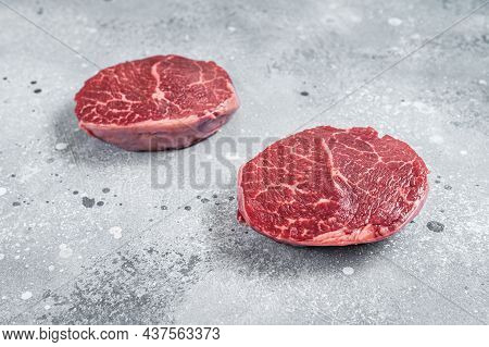 Raw Fillet Mignon Beef Steaks On A Butcher Board. Gray Background. Top View