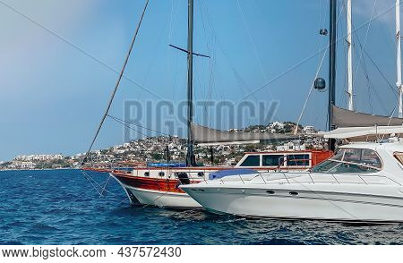 View Of The Embankment Of A Resort Town In Turkey With Boats Moored At The Pier Overlooking The Moun