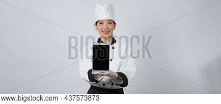 Asian Woman Chef Holding Smartphone Or Digital Tablet And Received Order From Online