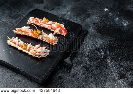 Crab Leg Meat In A Sheel With Herbs. Black Background. Top View. Copy Space