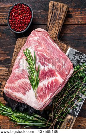 Pork Shoulder Raw Meat For Fresh Steaks On Wooden Cutting Board With Butcher Cleaver. Dark Wooden Ba